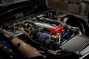 Close-up view of a car engine with detailed mechanical components and gauges, symbolizing the precision and care needed for effective maintenance.